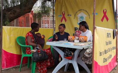 A mother consults with health workers in Tanzania.